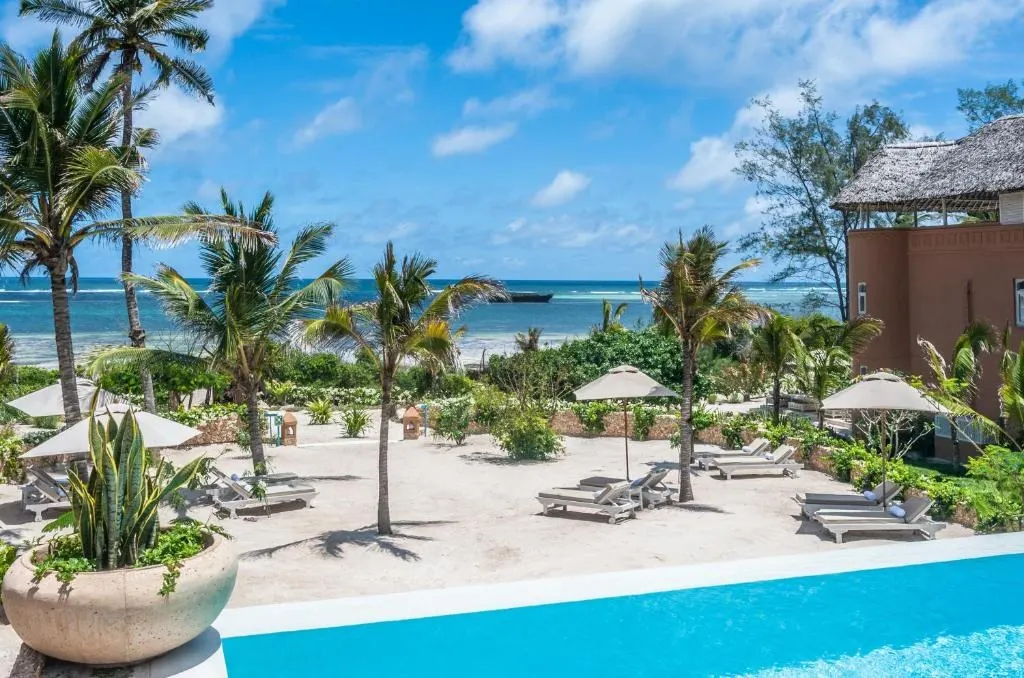 Pool and gardens overlooking the beach at Medina Palms