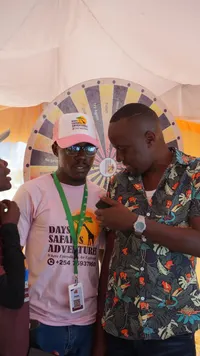 Consultant talking to a client by the prize wheel